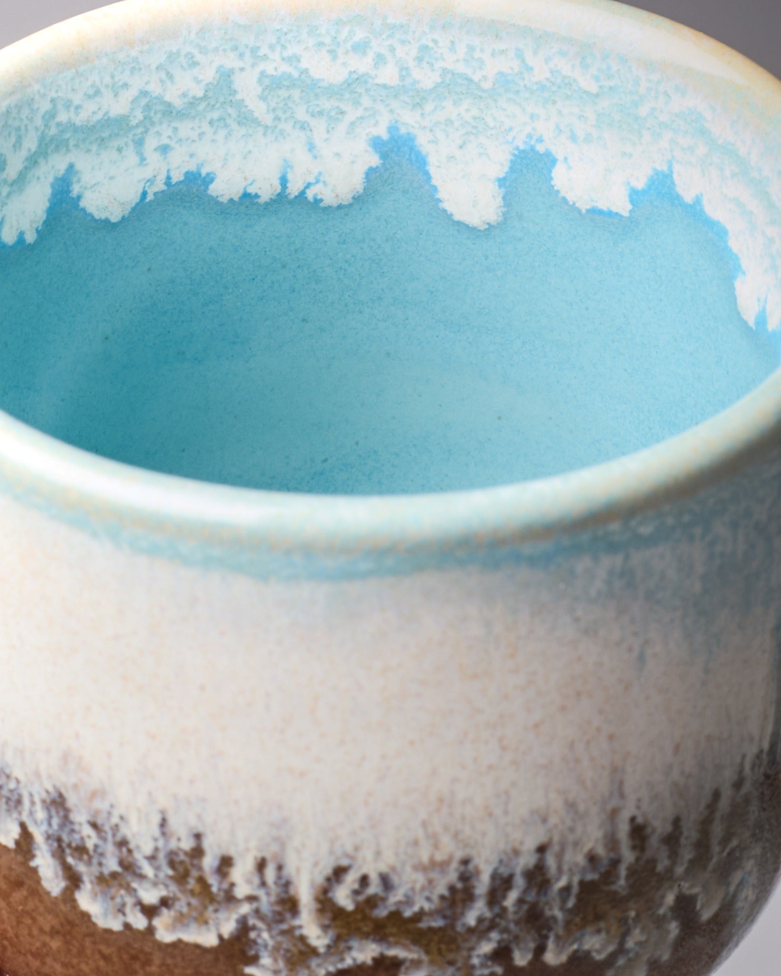 Nahaufnahme einer Keramikschale mit blauem und weißem Farbverlauf sowie texturiertem Rand.