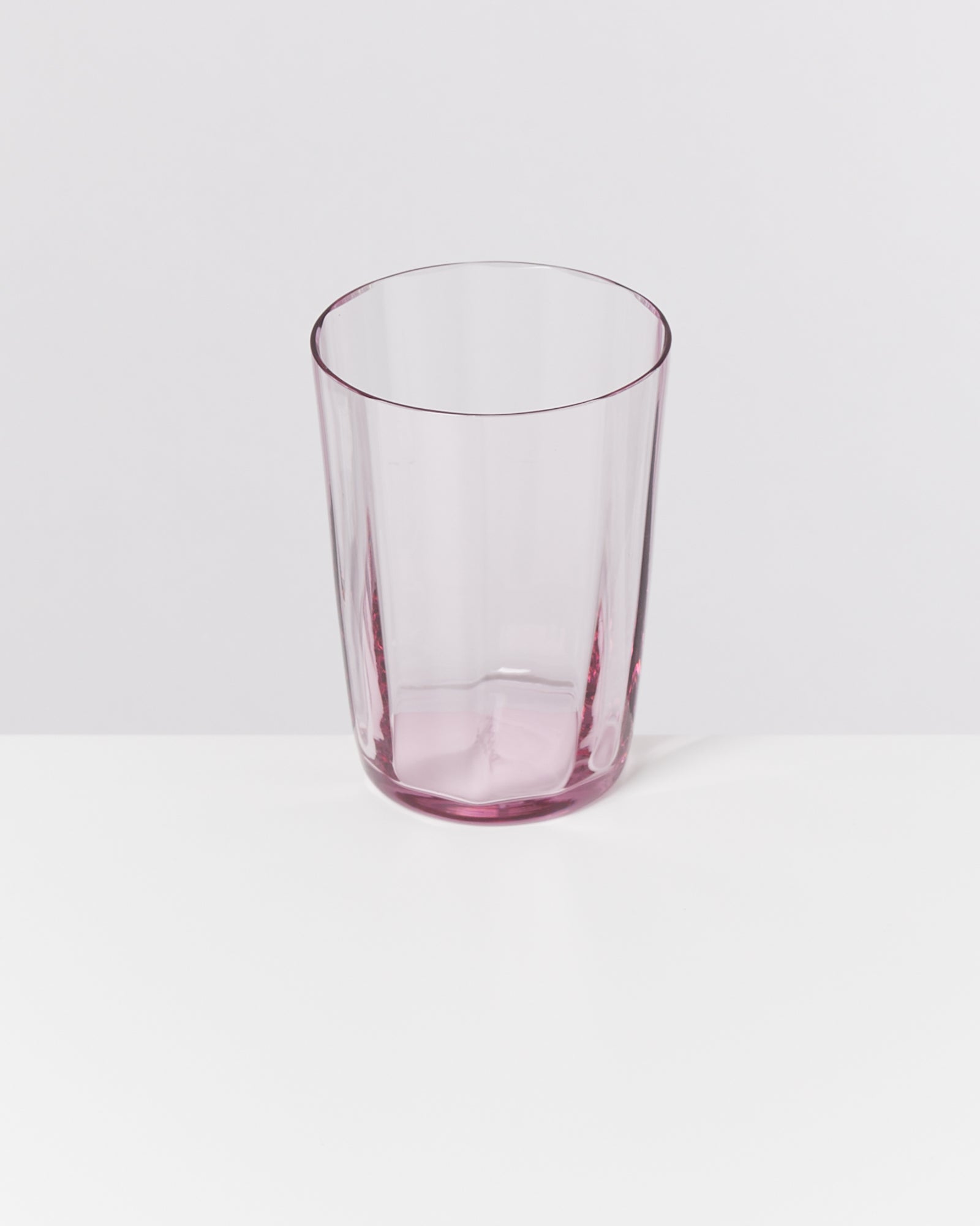 Rosa, transparentes Glas auf weißem Hintergrund.