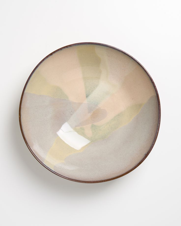 Keramikteller mit abstraktem, pastellfarbenem Muster auf weißem Hintergrund.