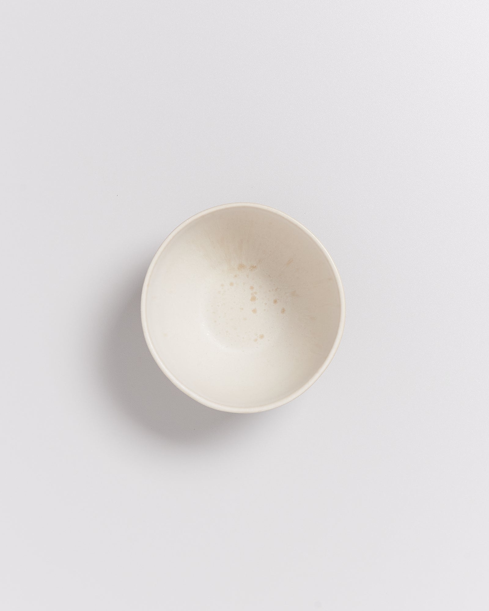 Leere, weiße Schale mit leichtem Muster auf einem weißen Hintergrund.